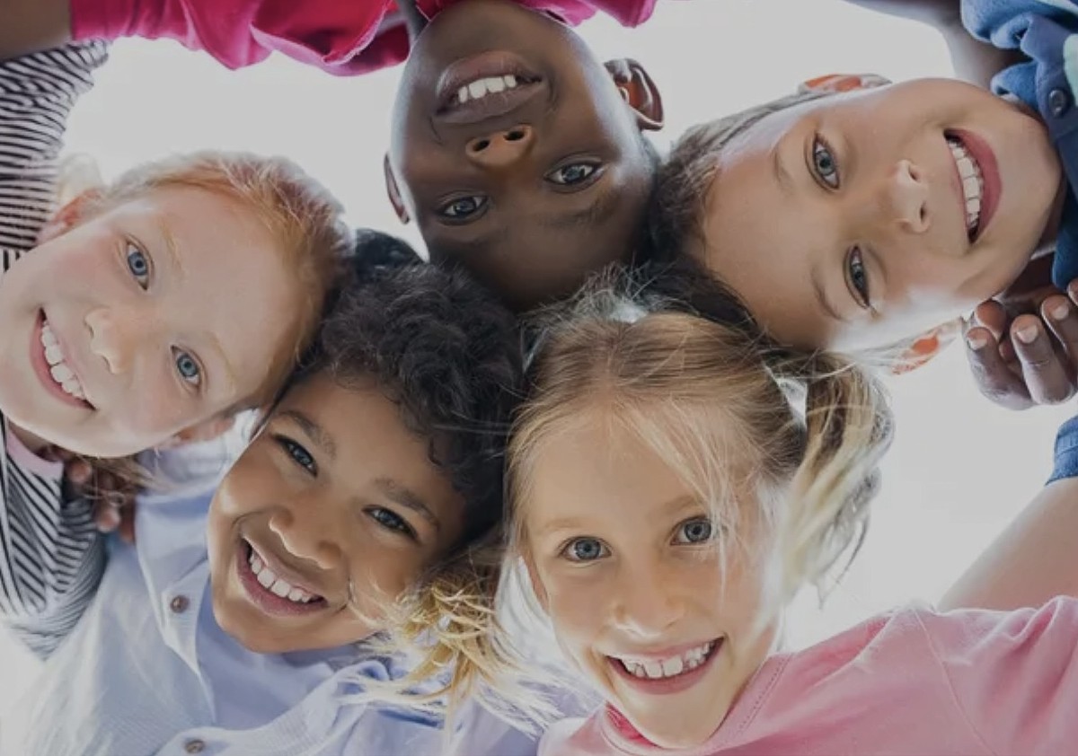 Children smiling in a circle together